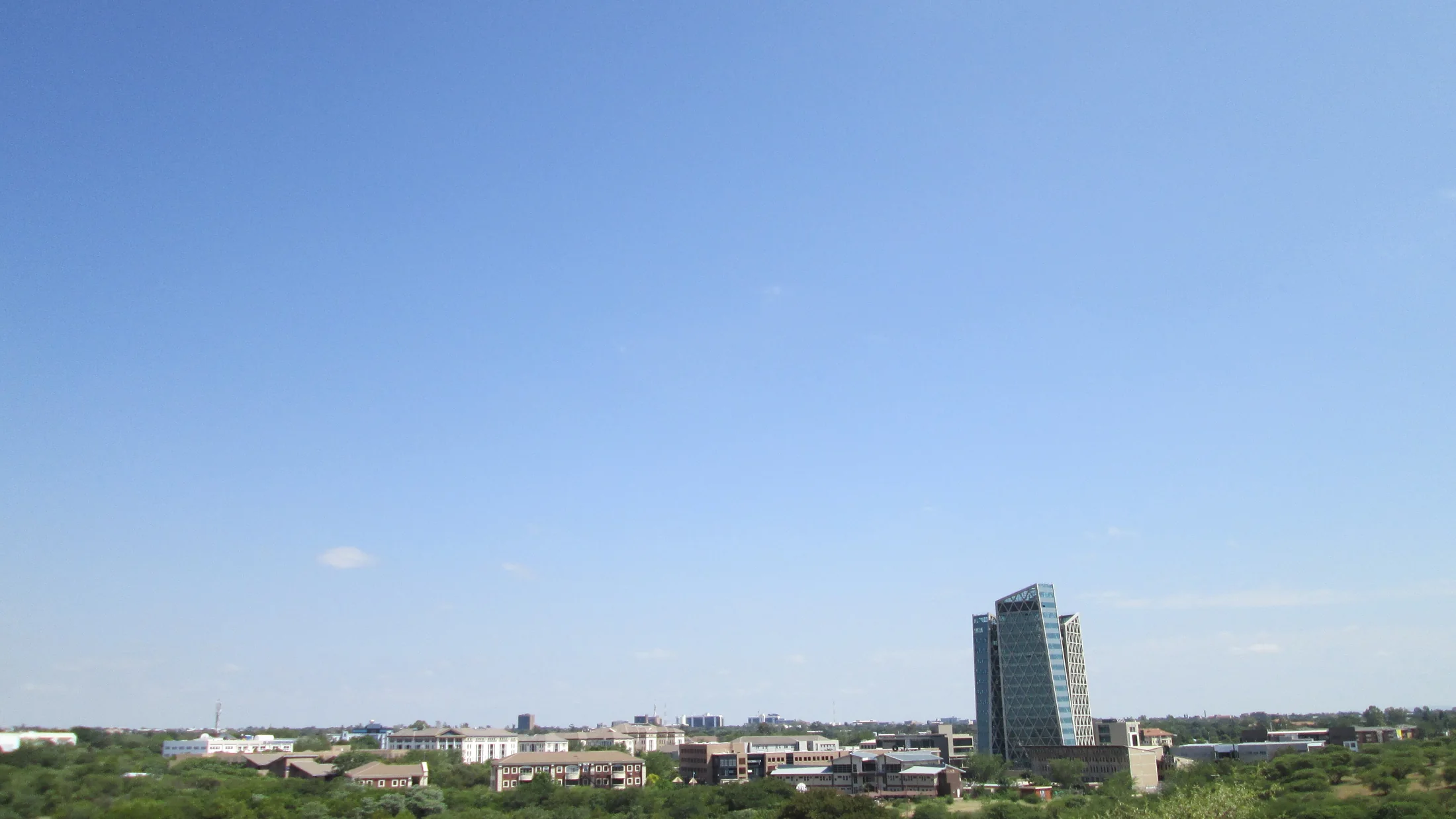 Gaborone city skyline beneath a clear blue sky