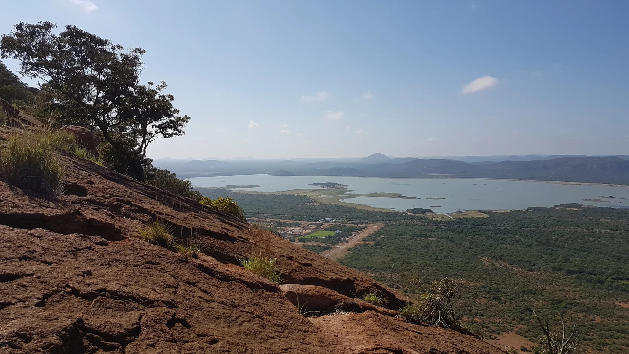 Rocky slope and trees overlooking Gaborone Dam from Kgale Hill